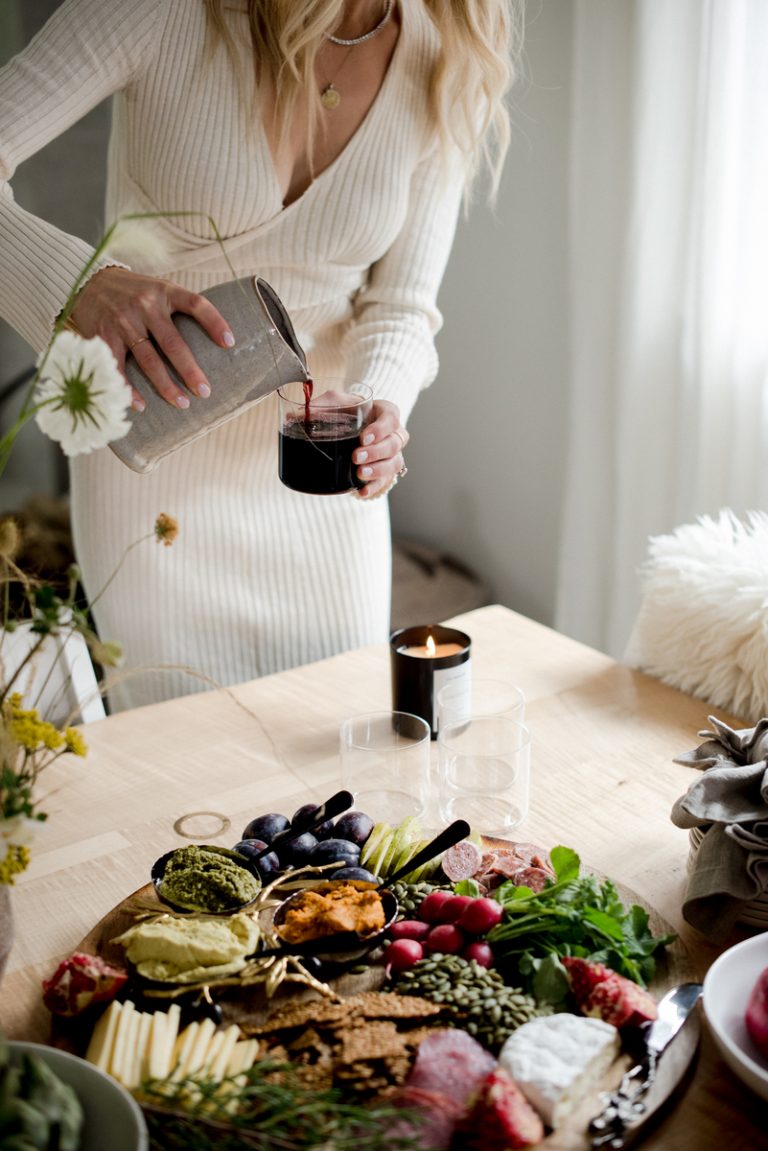 Woman pouring red wine alcohol and gut health