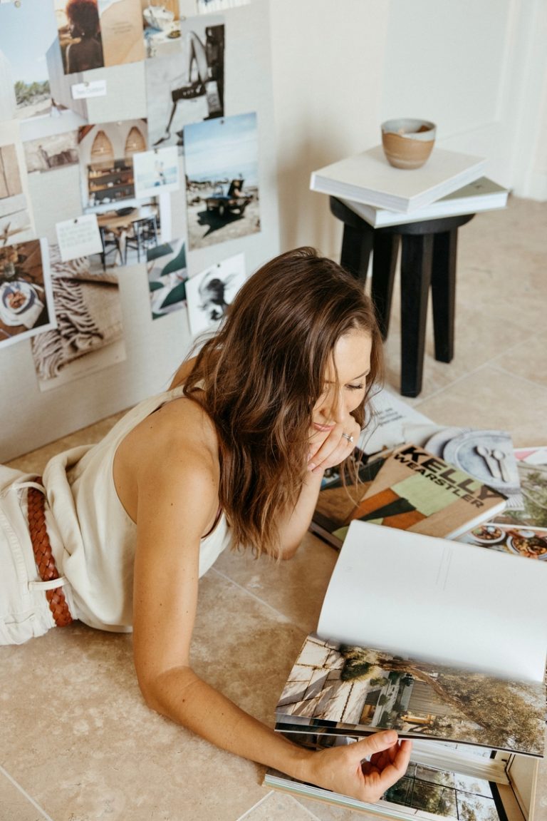 woman looking at magazines winter bucket list