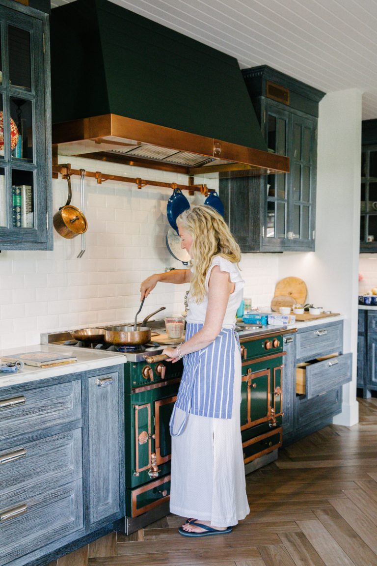 woman cooking in kitchen dinner party etiquette