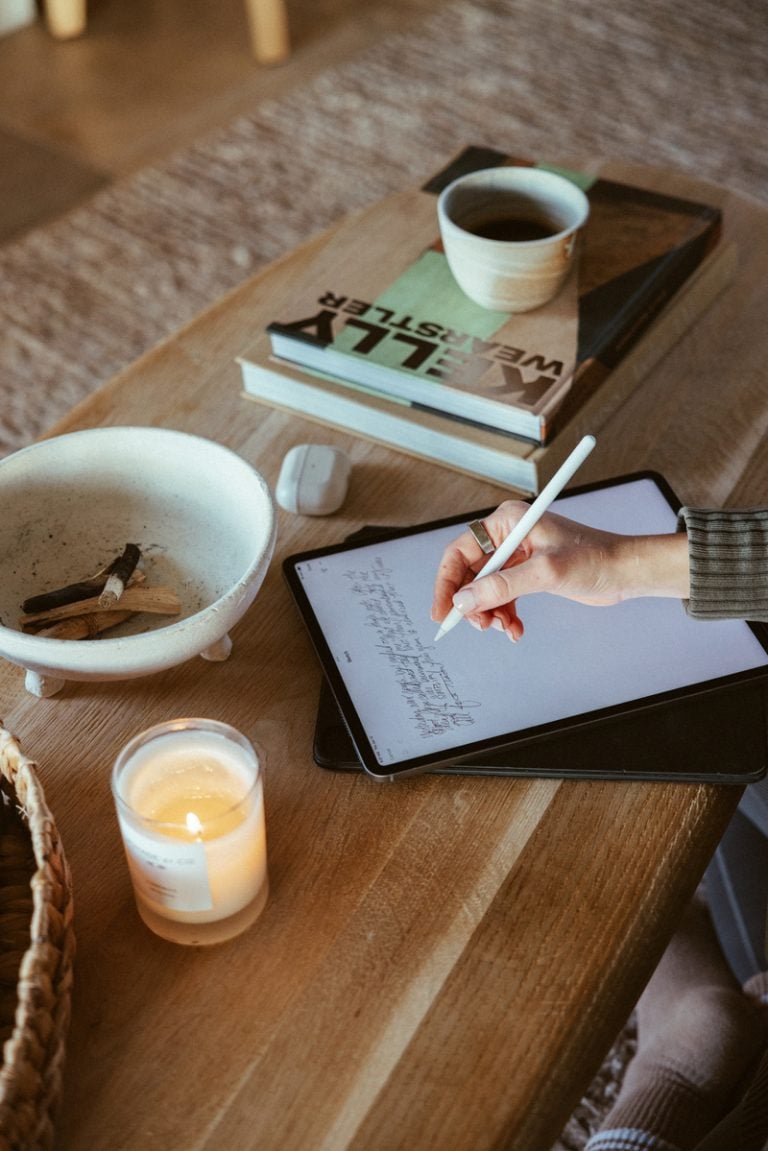 A woman journaling on an iPad How to reduce inflammation