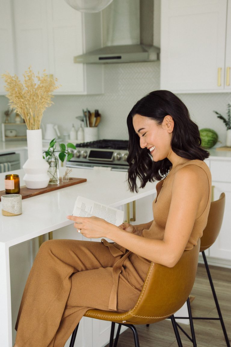 brunette woman reading at kitchen counter five-minute tasks