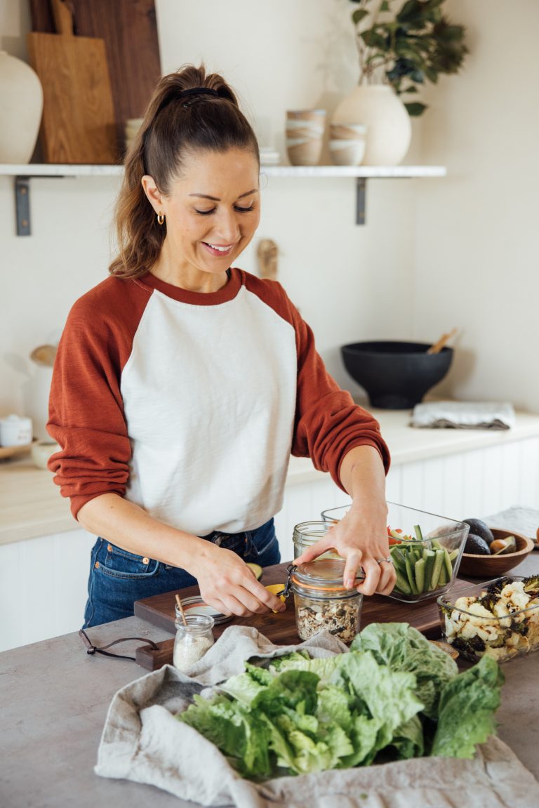 Camille Styles meal prepping in kitchen.