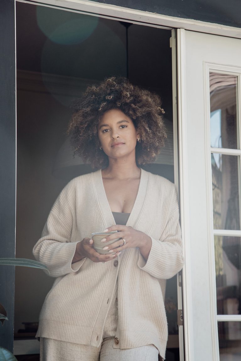 woman wearing loungewear holding tea