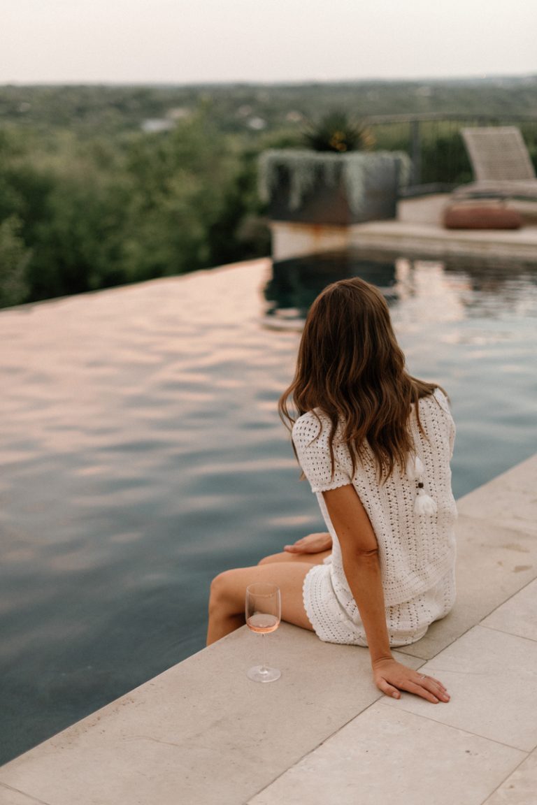 woman drinking wine by pool, a heart that works