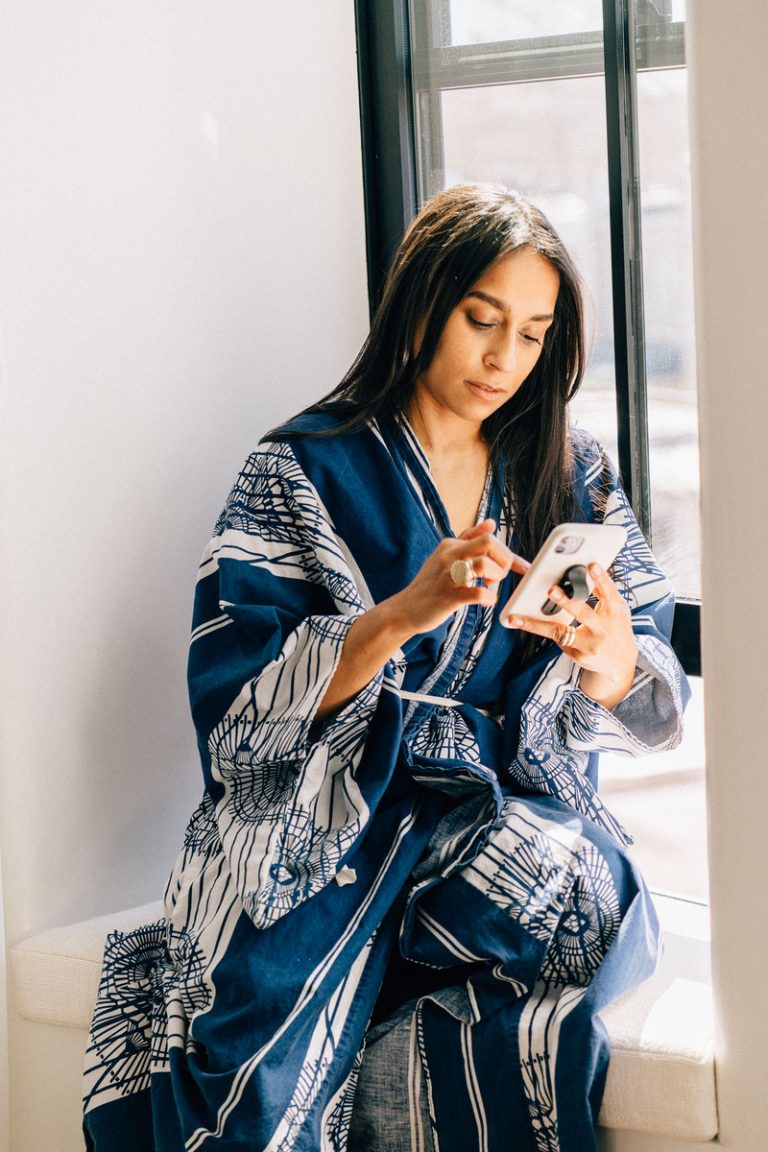 woman in robe using phone