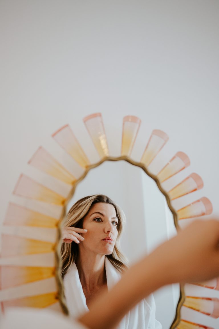 woman looking in mirror