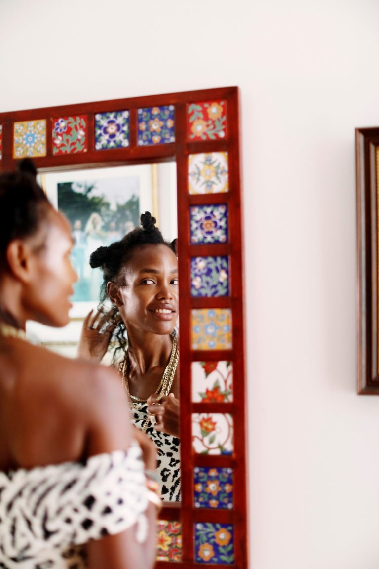 woman looking in mirror