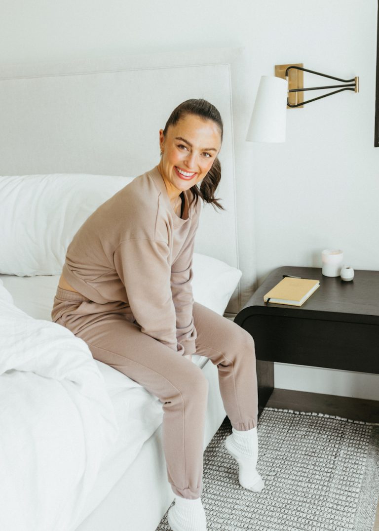 woman sitting on bed