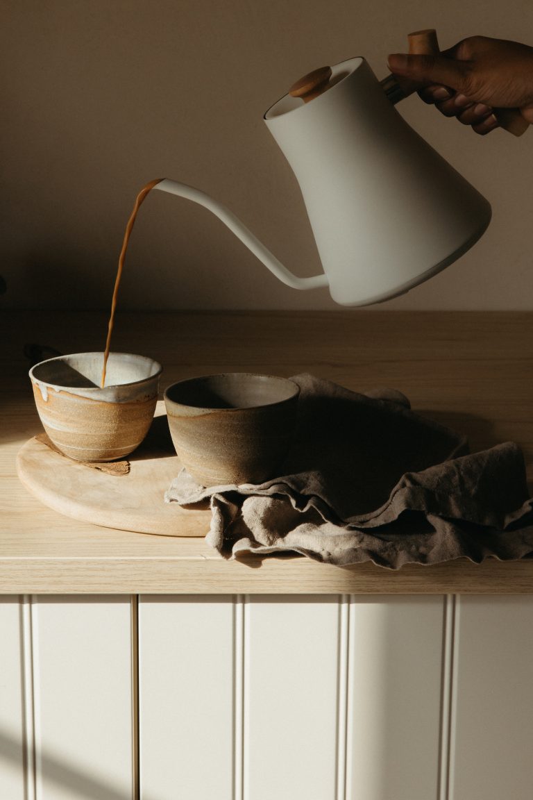 Pouring tea into ritual mug. 