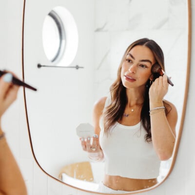 Woman applying makeup.