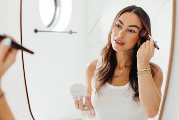 Woman applying makeup.