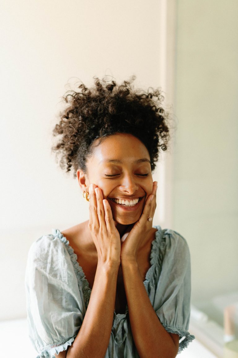 Smiling woman doing skin care