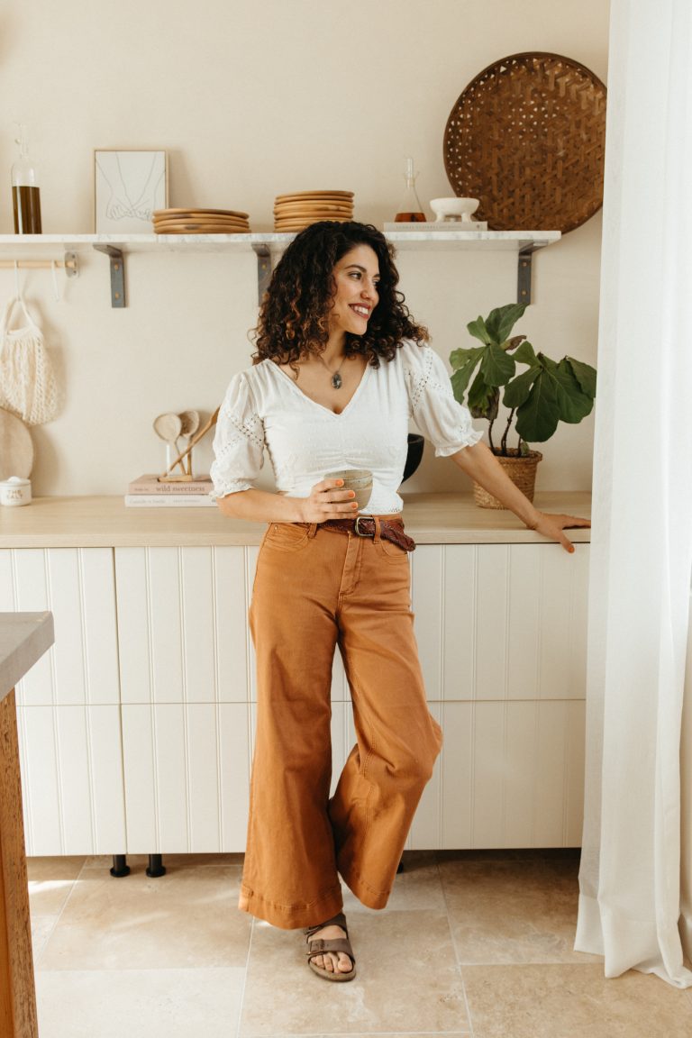 Woman drinking coffee in the kitchen.