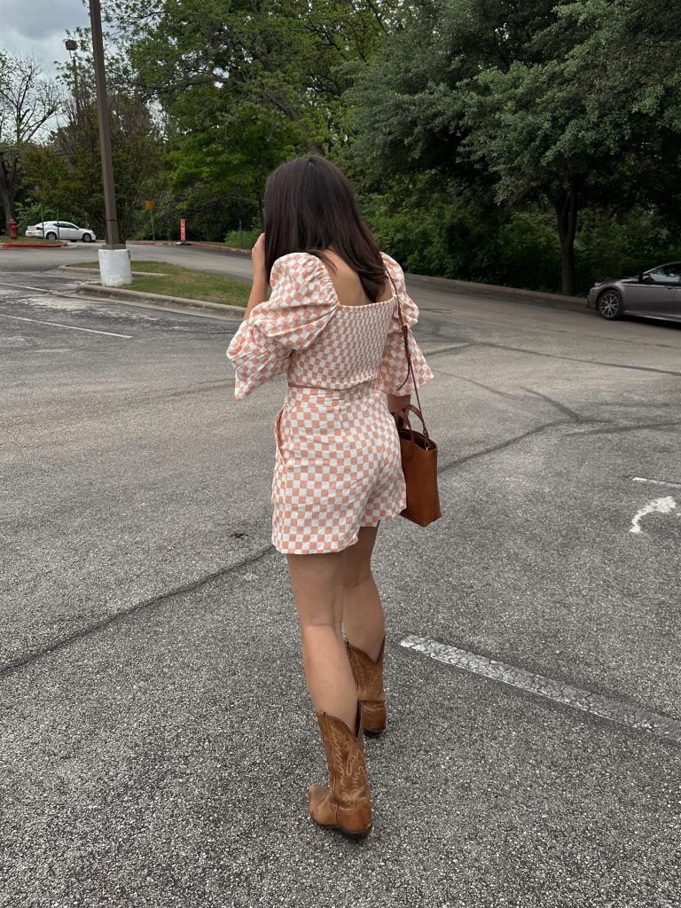 brunch outfit idea: woman in matching gingham set with cowboy boots