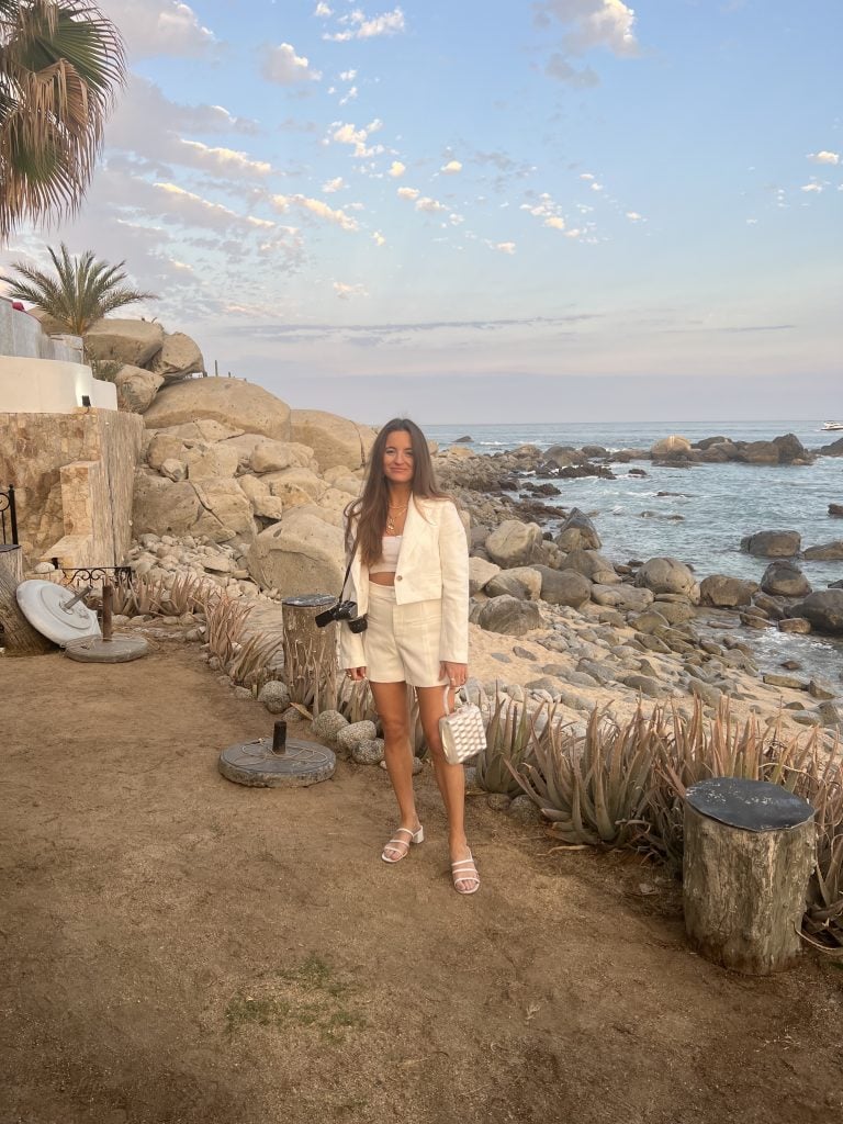  woman wearing white shorts with matching Zara blazer and Reformation sandals