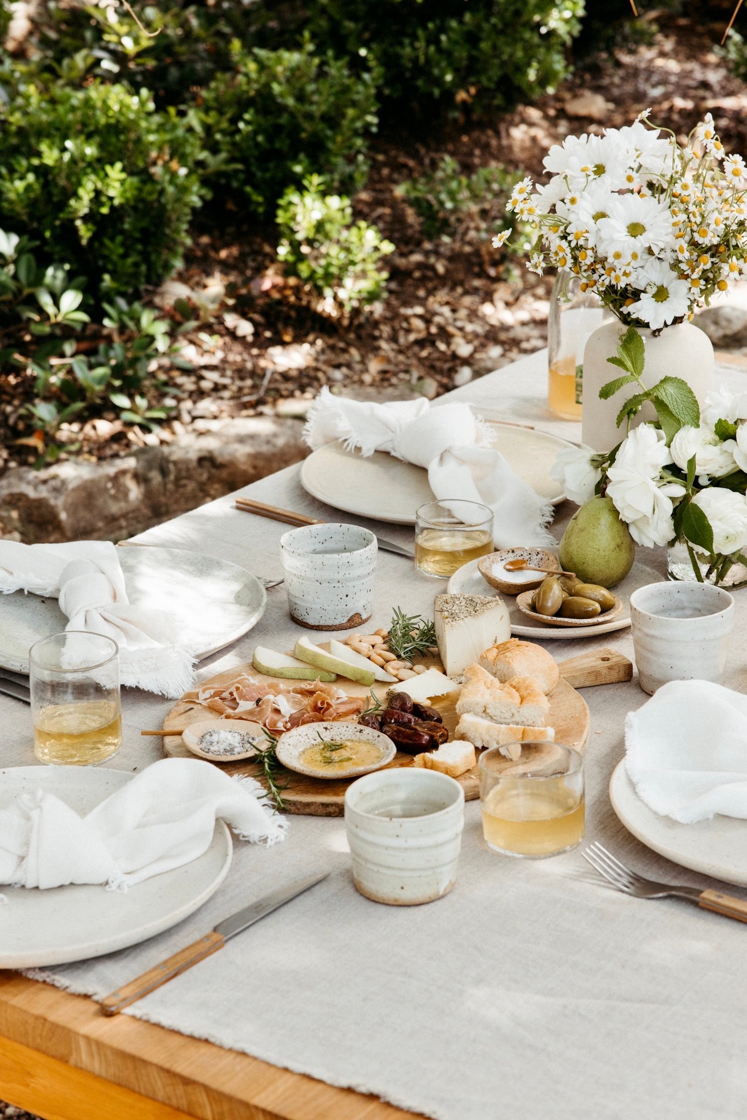 dinner party table setting with spring cheese board, casa zuma solstice mugs