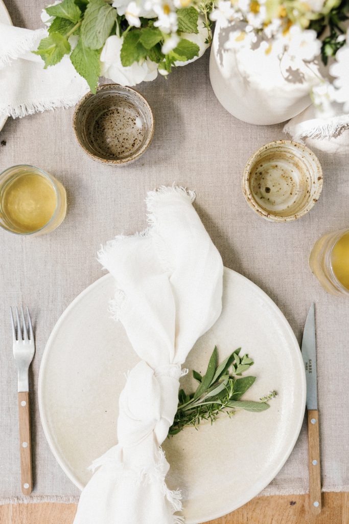 how to knot a linen napkin, herbs, casa zuma solstice mug, recycled glassware, handmade dinner plate