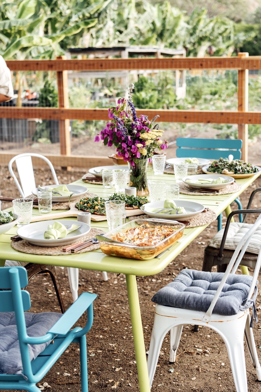 colorful mismatched seating for dinner party table setting and decor