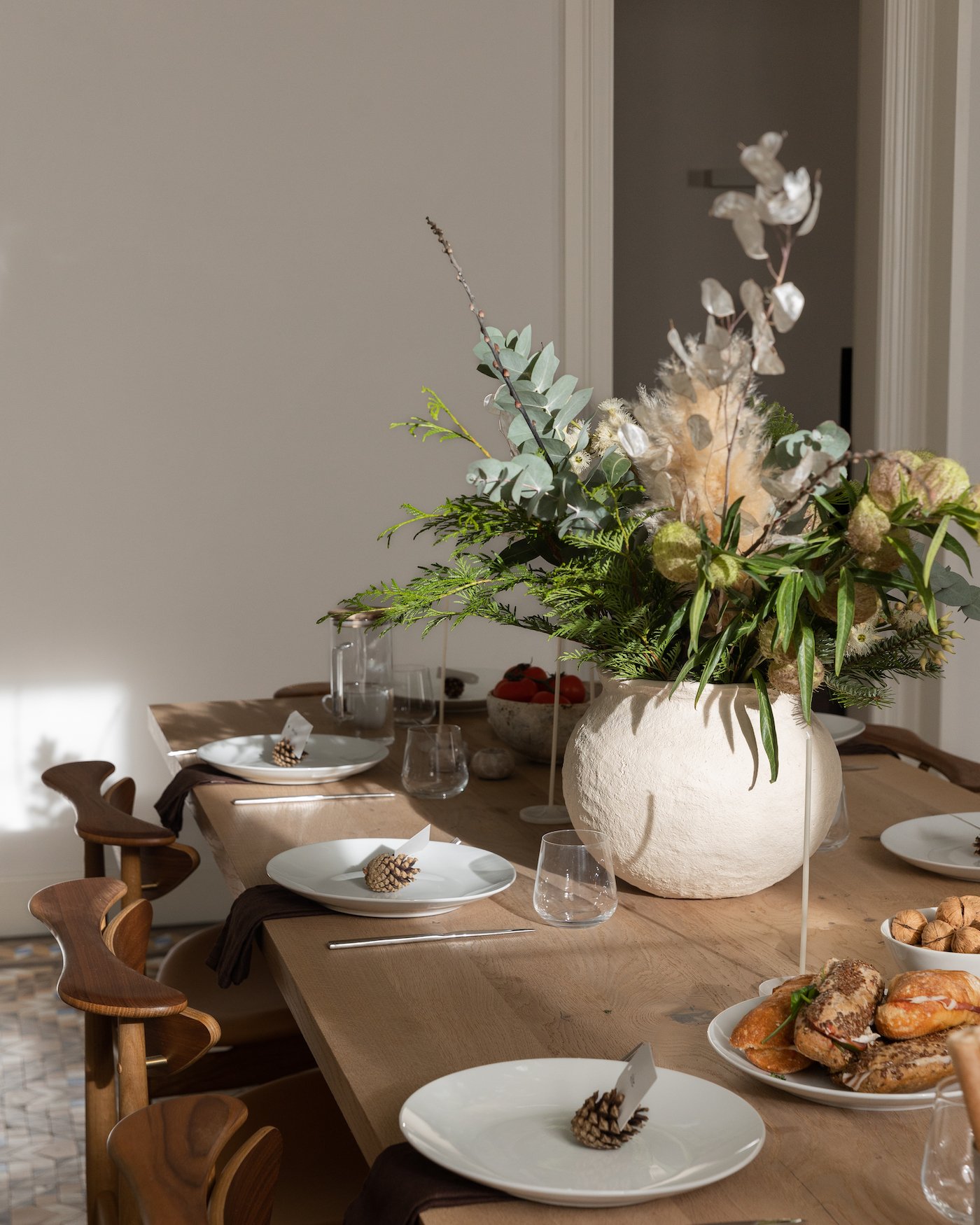 minimalist table decor for dinner party with pinecone placecards