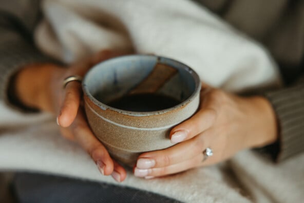 hands holding ritual cup