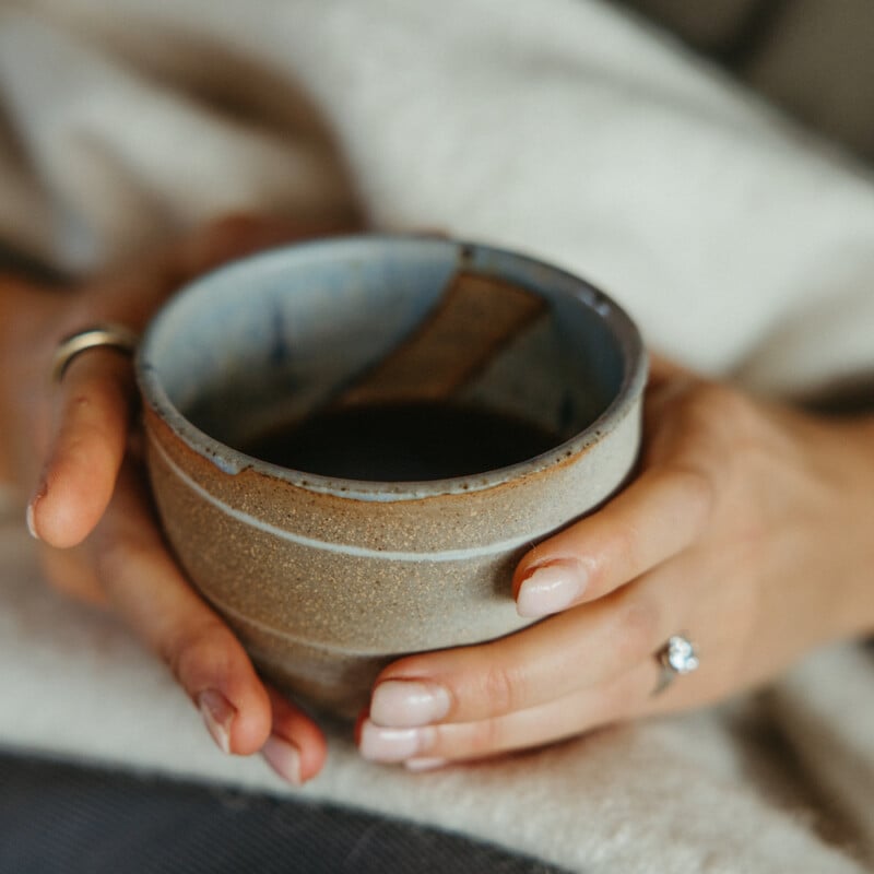 hands holding ritual cup