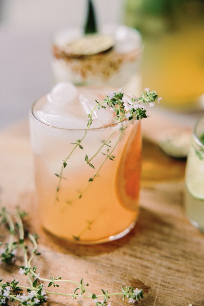 kombucha paloma cocktail with sliced grapefruit and rosemary