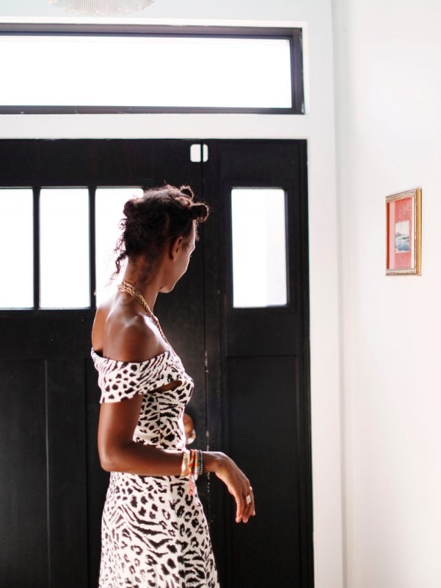 Black woman wearing zebra print off-the-shoulder dress.
