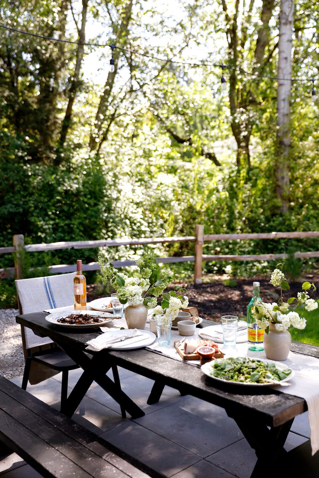 black picnic table with runner and dinner party table settings