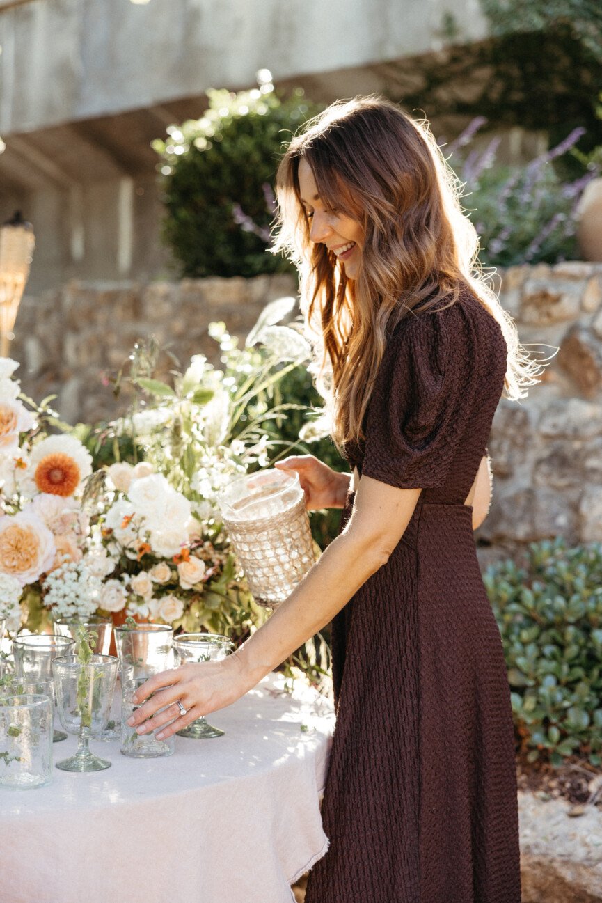 spring garden table with flowers, pouring water