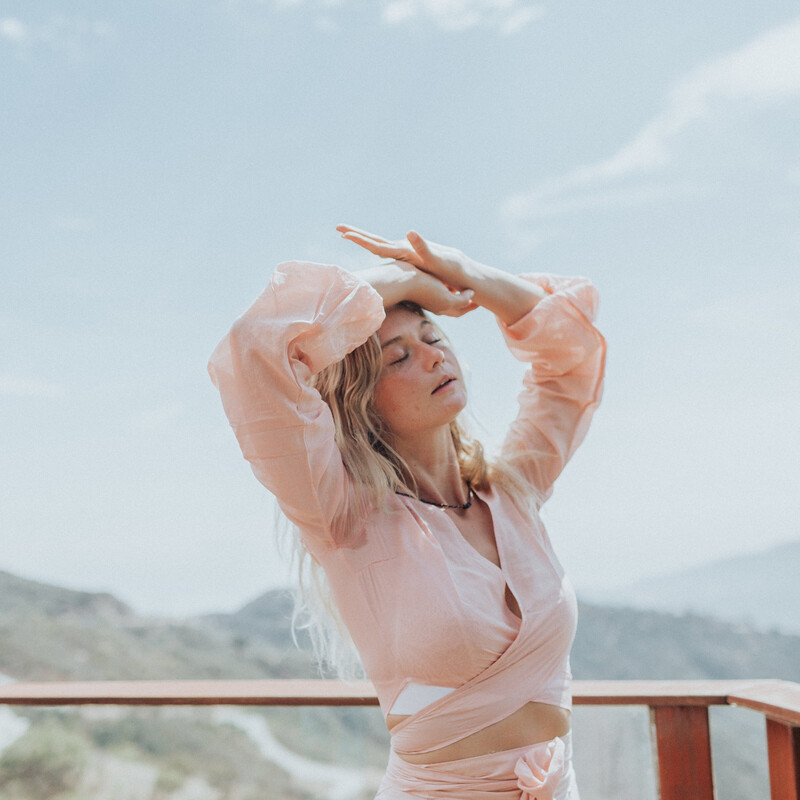 blonde woman basking eyes closed in the sun in Malibu