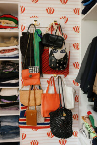 closet clean out with organized purses on the wall