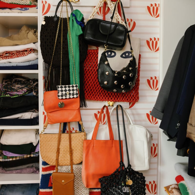 closet clean out with organized purses on the wall