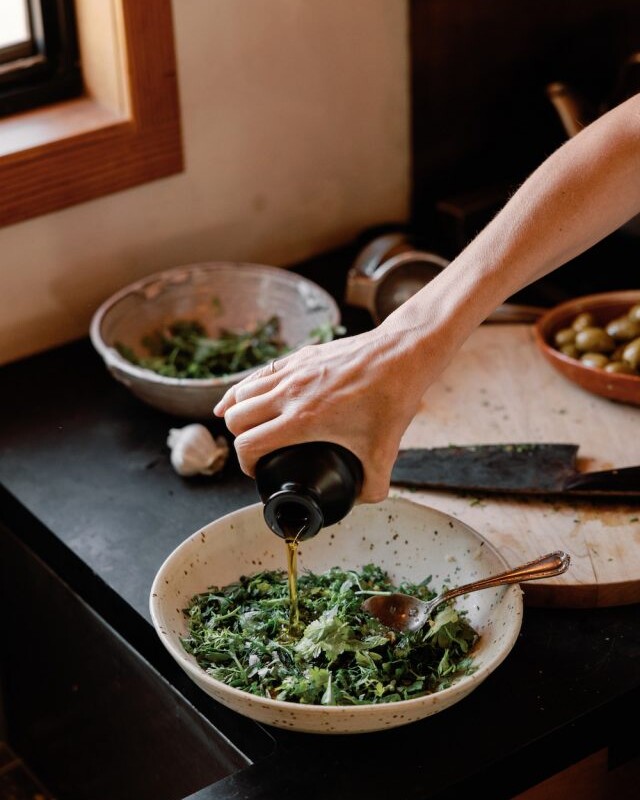 pouring olive oil into Italian salsa verde