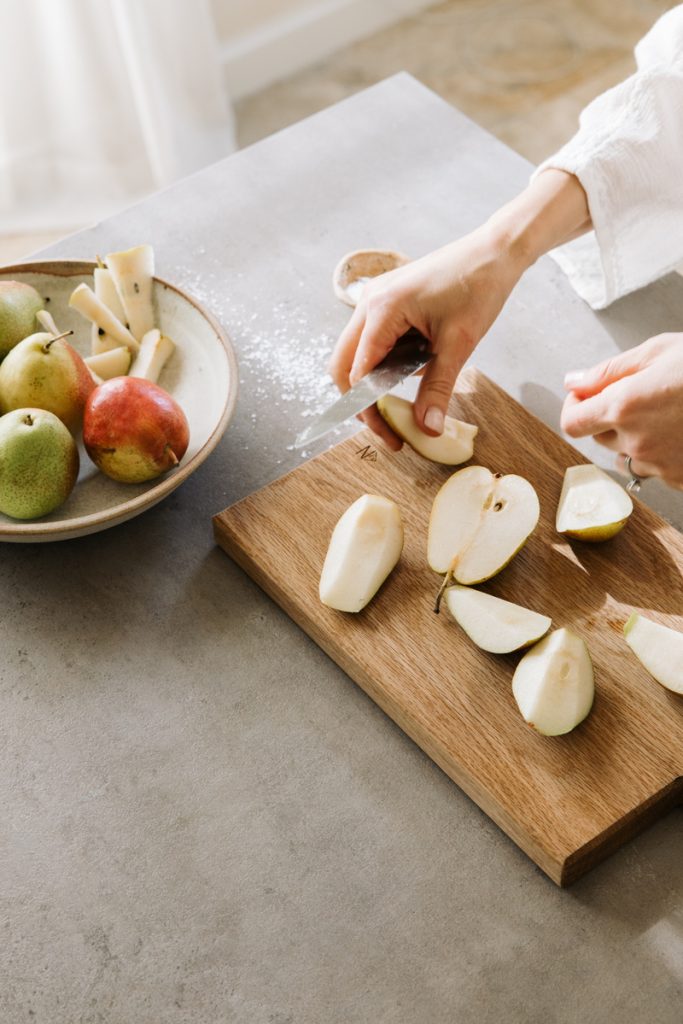 Cutting pears on wood cutting board