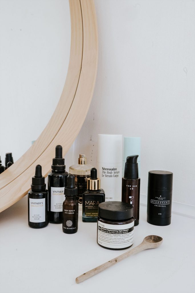 Skincare products on white vanity.