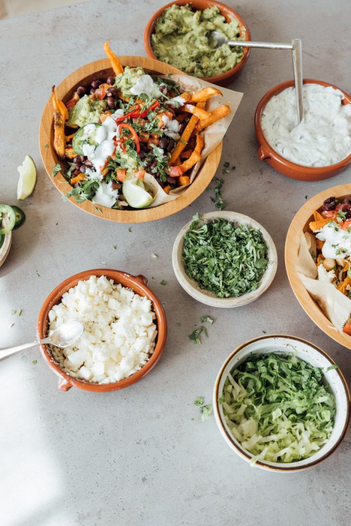 Loaded sweet potato fries with toppings.