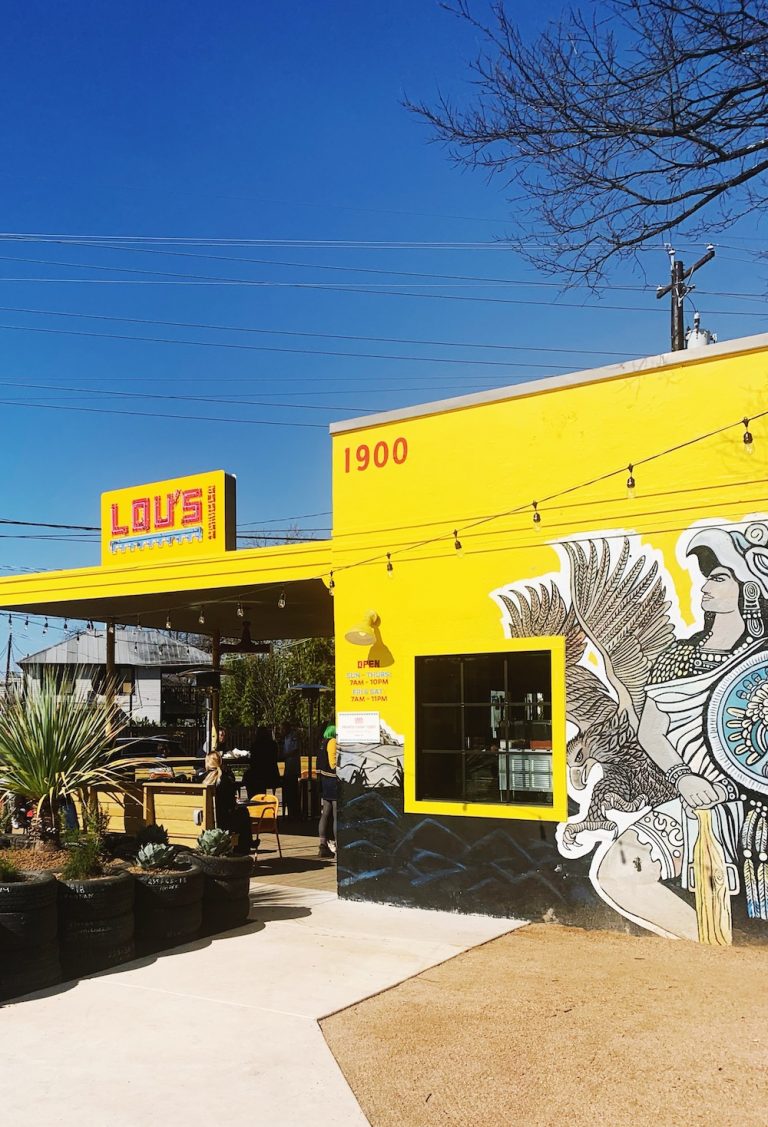 Bright yellow exterior of Lou's restaurant in Austin, Texas.