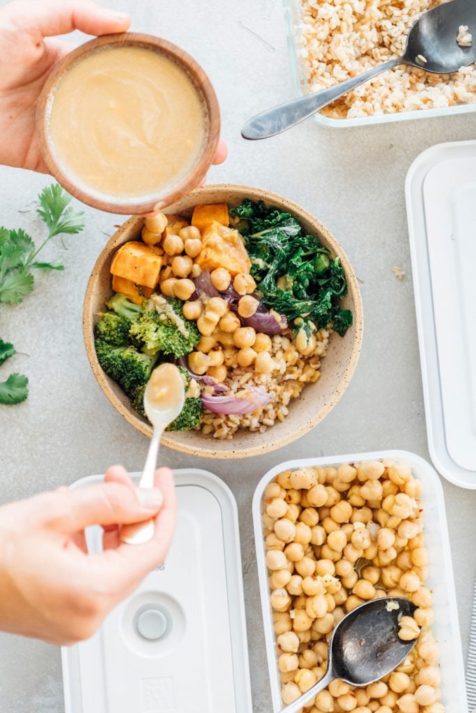 Meal prep grain bowl with broccoli, chickpeas, kale, sweet potatoes.