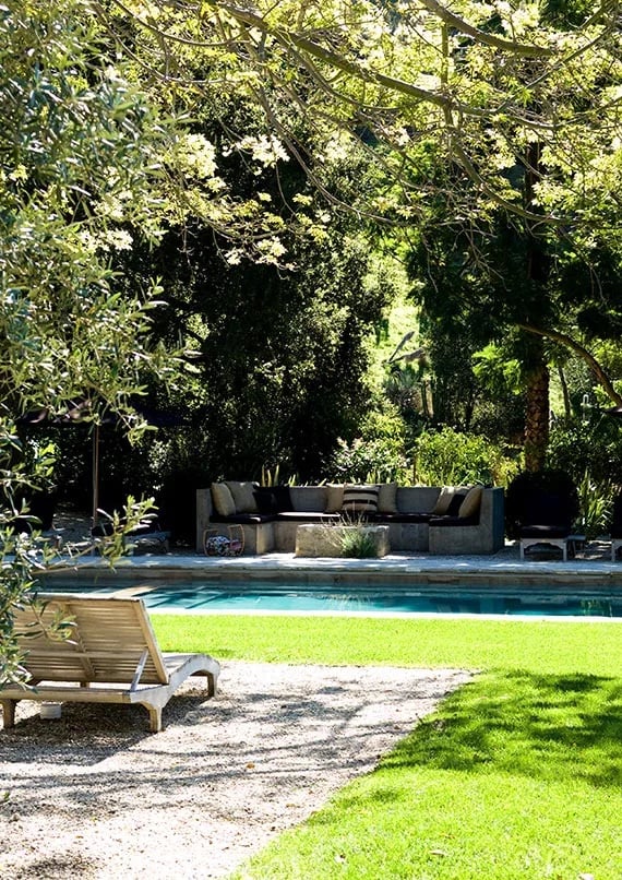 Backyard outdoor pool with couch and seating.