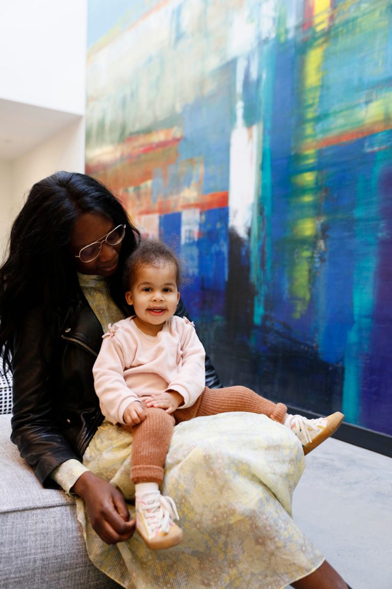 Woman sitting with toddler on lap.