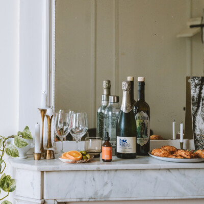 Wine bottles and glaasses on a white marble mantle - Joann Pai Photography