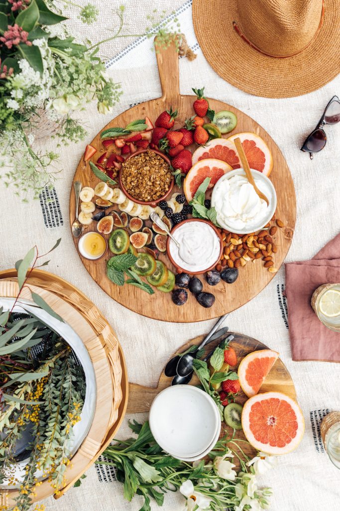 Picnic breakfast with yogurt, fruit, and granola.