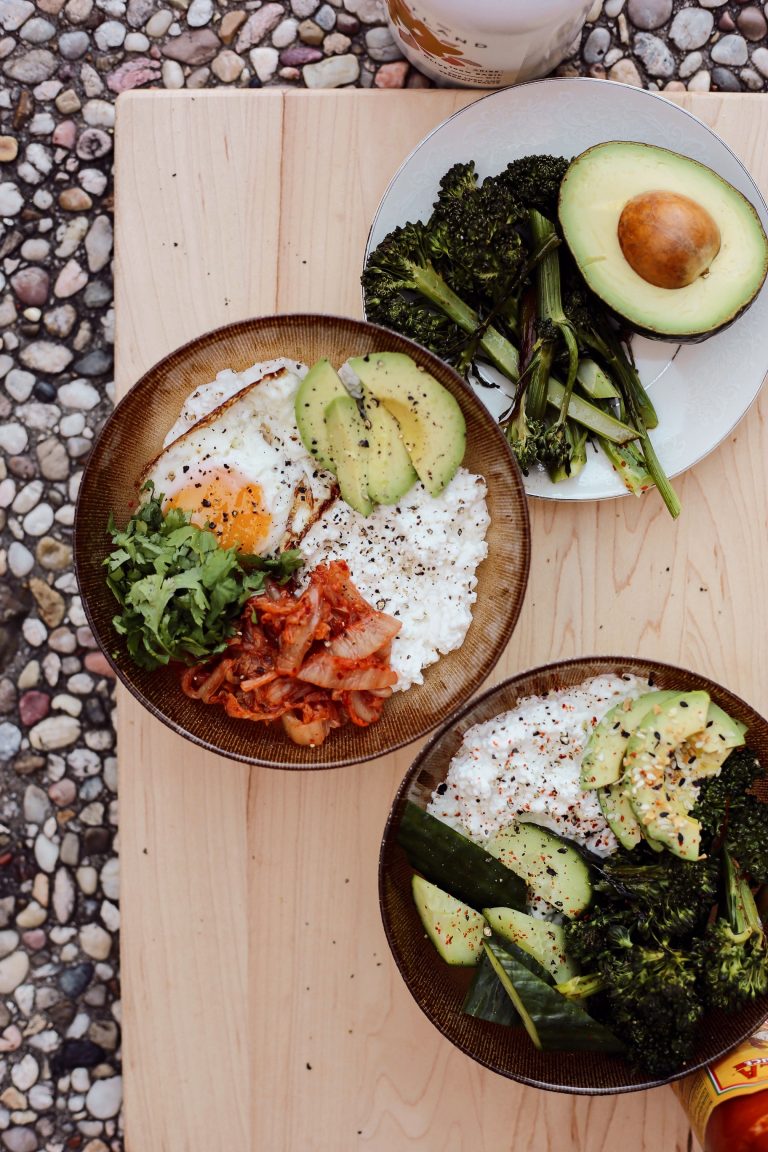Savory cottage cheese breakfast bowls with spinach, broccoli, eggs, kimchi, and avocado.
