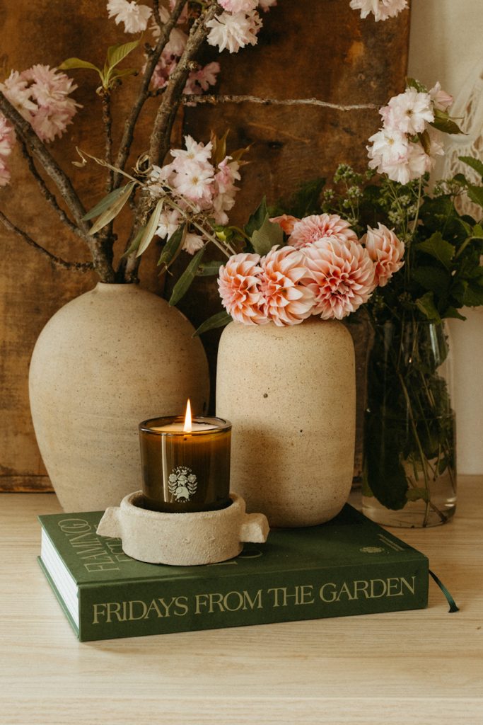 Flowers in stoneware vases and candle.