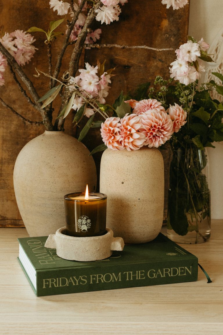 Flowers in stoneware vases and candle.