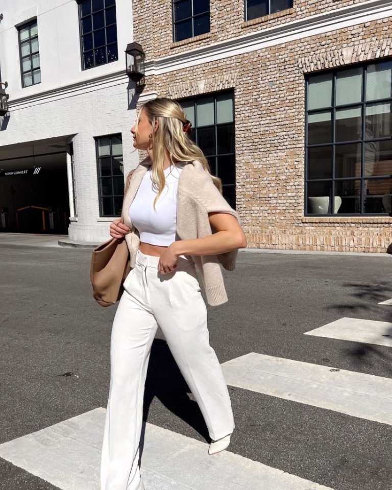 Blonde woman walking in crosswalk.