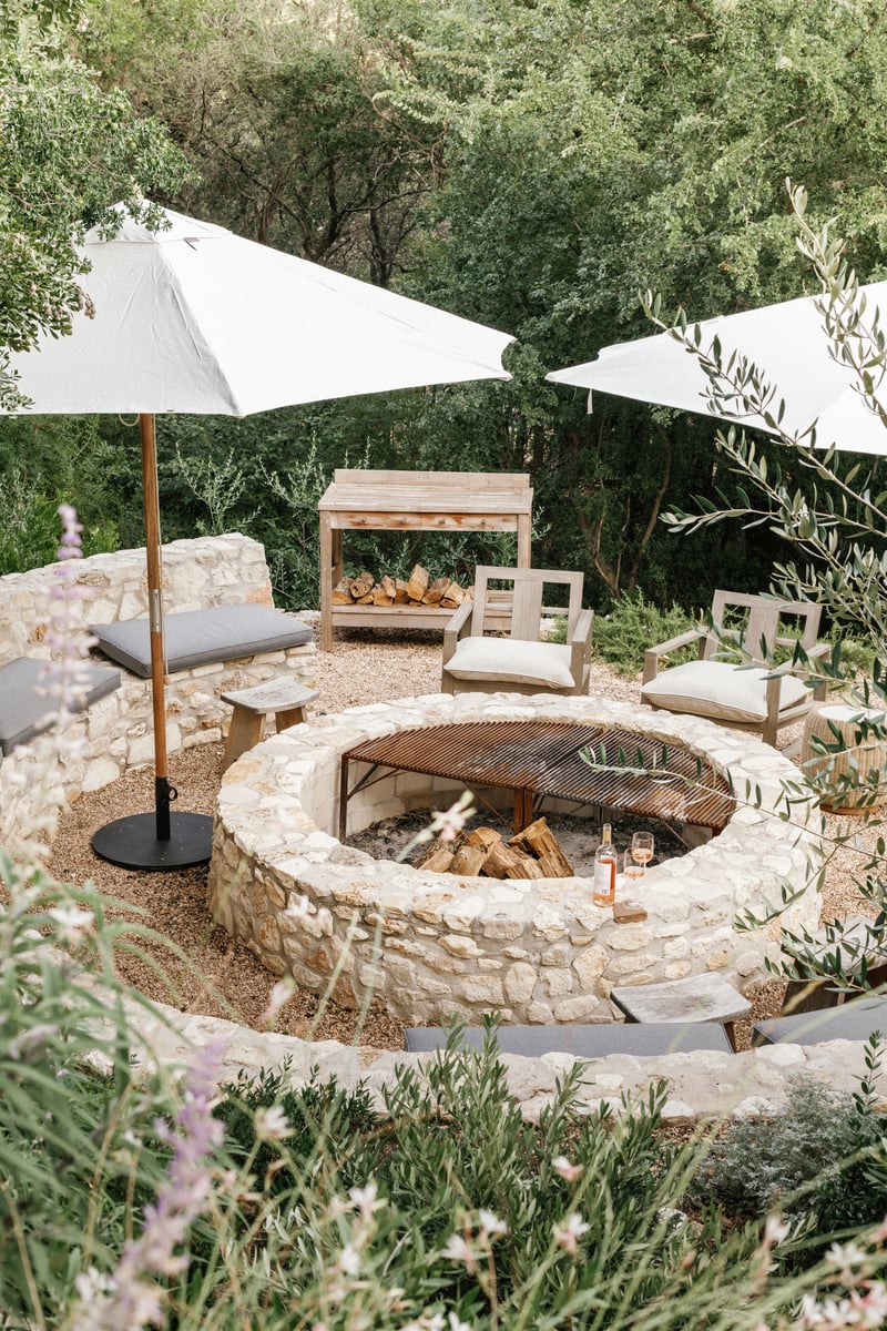 large stone fire pit in rustic backyard