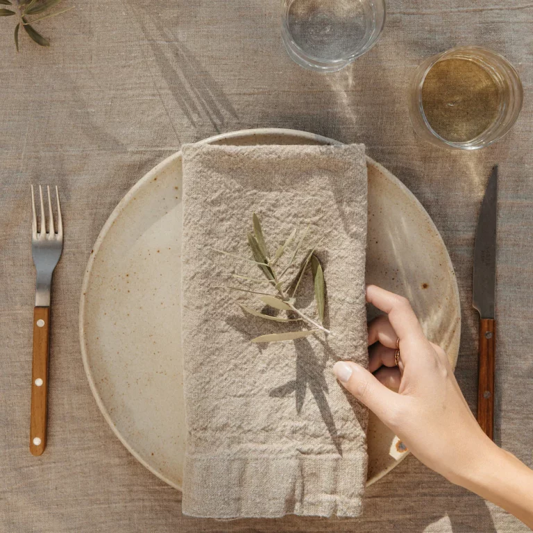 napkin being placed on table how to set a table with napkins