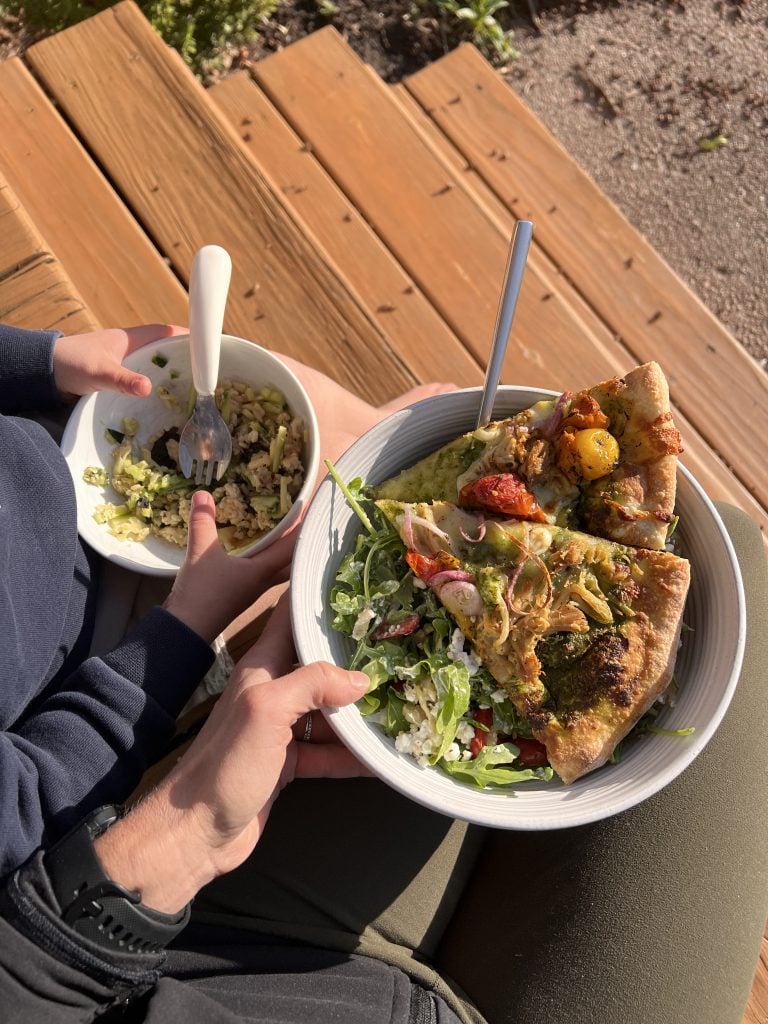 Bowls of pizza and salad eaten on porch