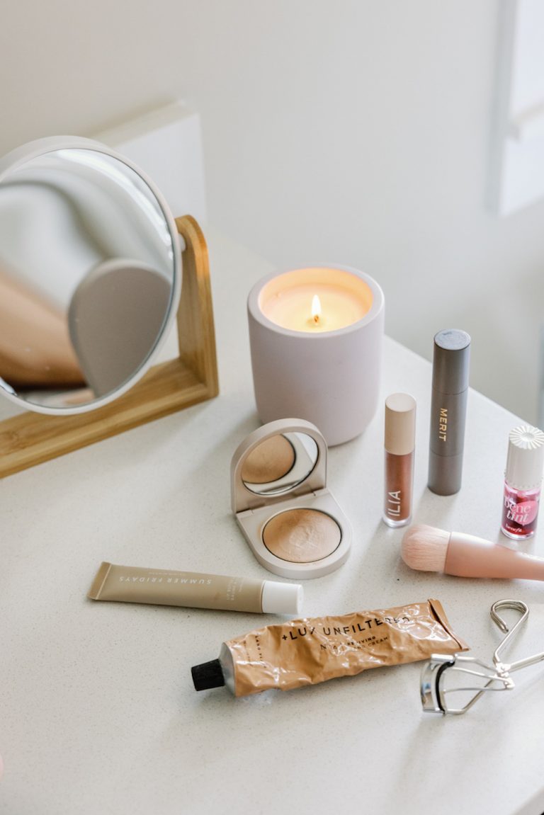 Makeup products on bathroom counter.